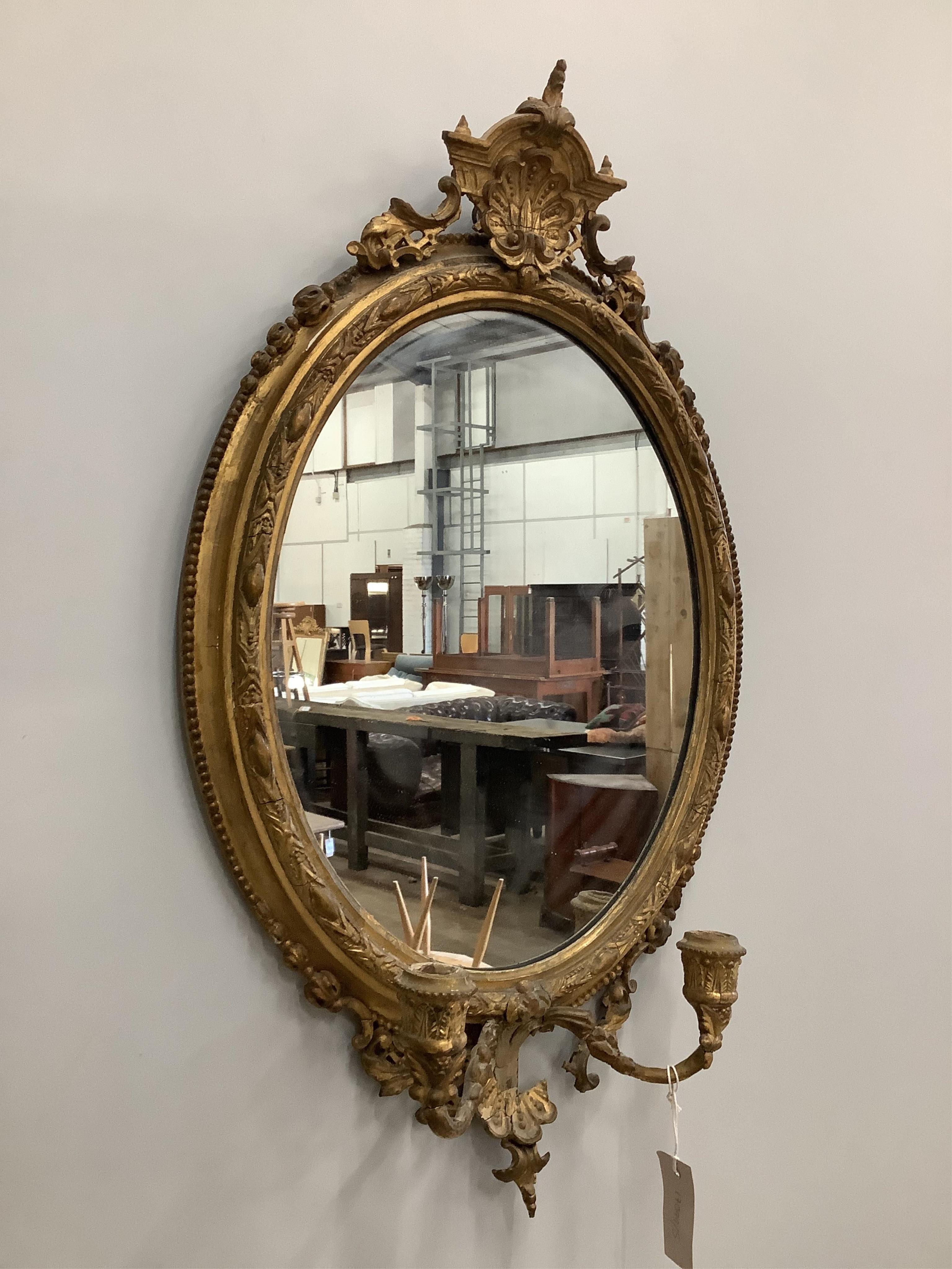 A Victorian giltwood and composition girandole wall mirror, width 43cm, height 73cm. Condition - poor to fair